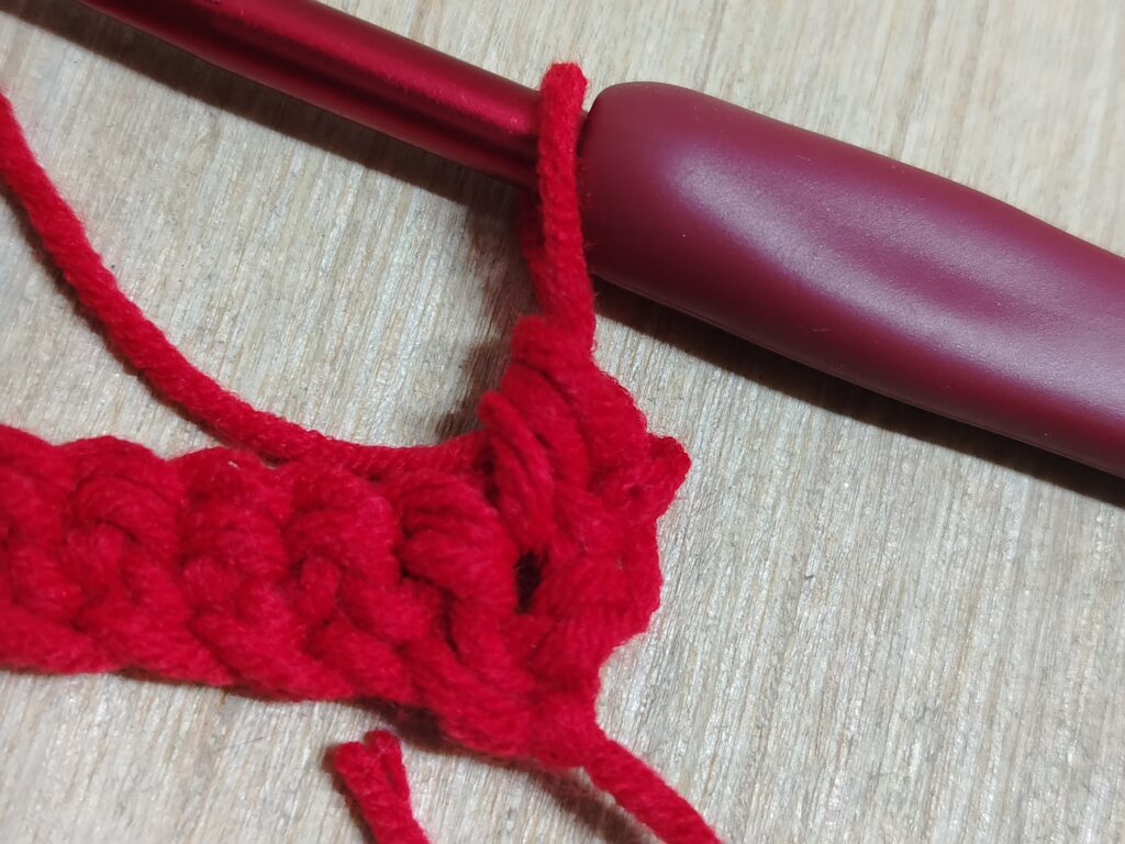 half double crochet in the first stitch of the previous row