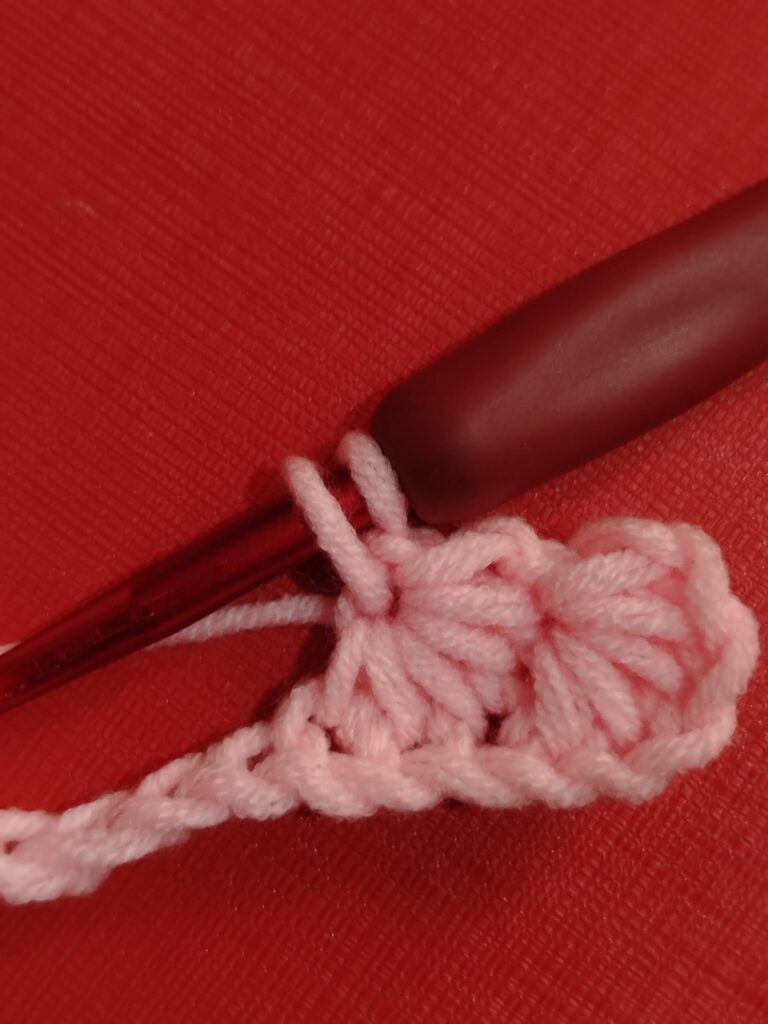 pull up a loop in the eye of the previous star stitch to make the next one