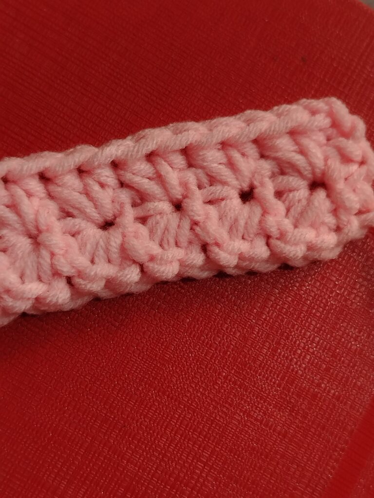 couple of half double crochets in each eye of the star stitch made in the previous row