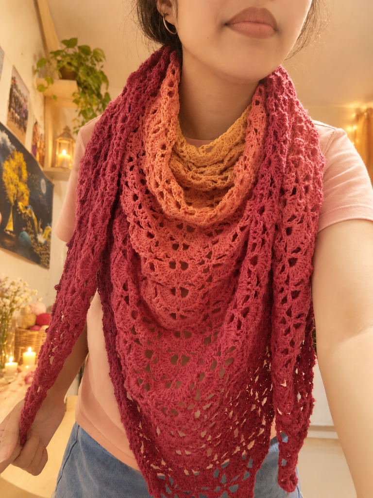 Handmade pink and peach crochet shawl worn as a cozy scarf